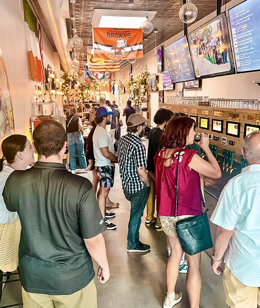 People enjoying Tapster, a self-pour bar in Cleveland.