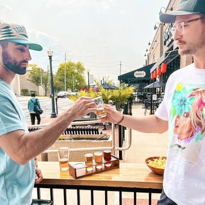 Tapster guests enjoying a flight of beers on the patio at Tapster Cleveland.